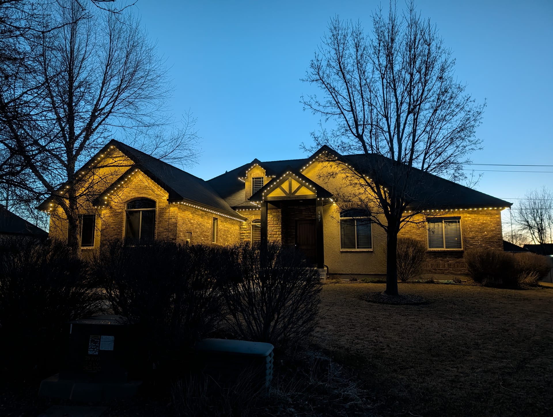 Warm white permanent LED trim lights on Idaho Falls home roofline at night