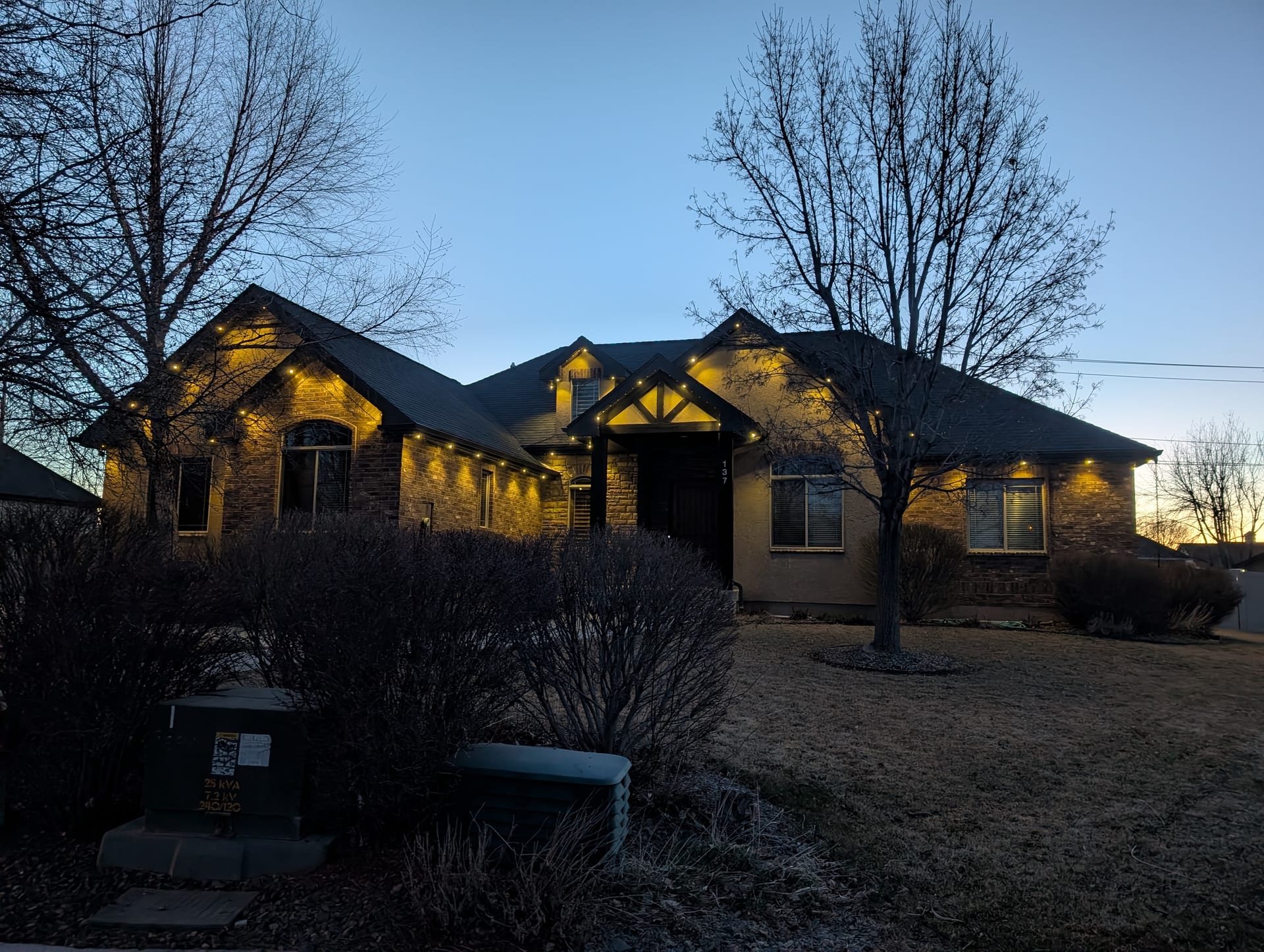 Warm white year-round LED roofline lighting on Idaho Falls home - permanent trim lights