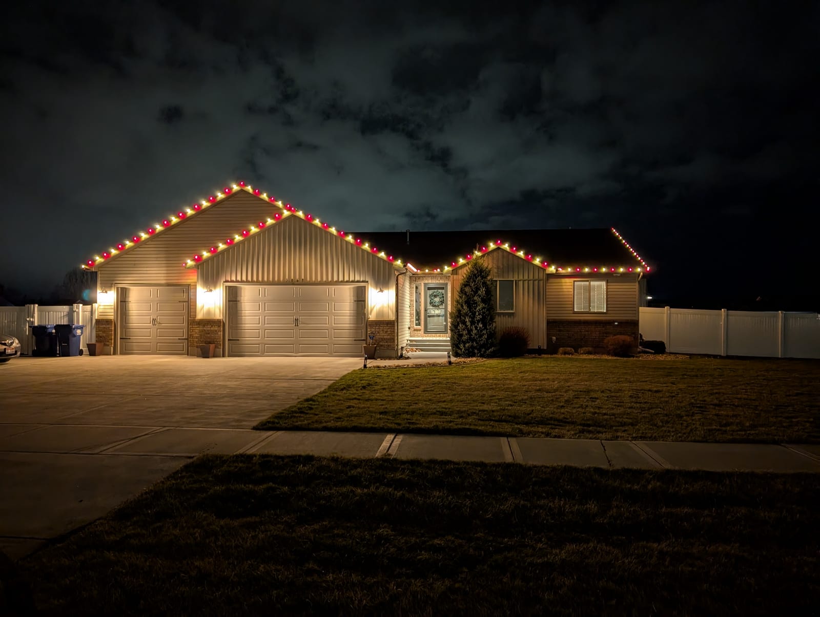 Red and gold traditional Christmas lights along home gables