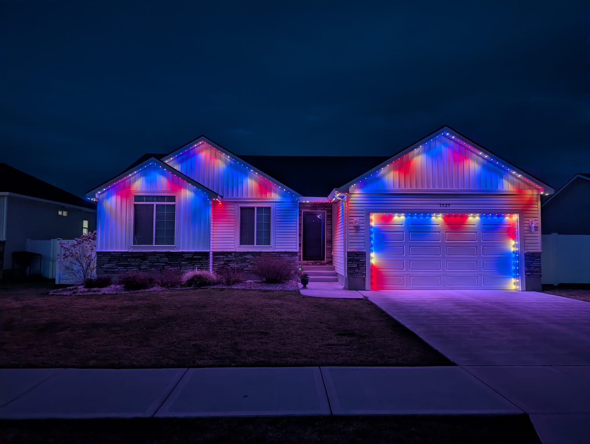 Year-round holiday LED roofline lights in patriotic red white blue - permanent outdoor lights Idaho Falls